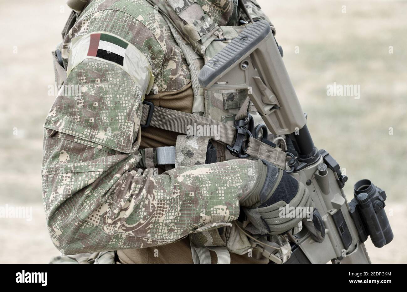 Soldier with assault rifle and flag of United Arab Emirates (UAE) on military uniform. Collage. Stock Photo