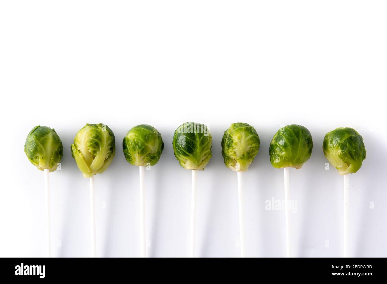 Set of brussel sprouts with lollipop sticks on white background Stock