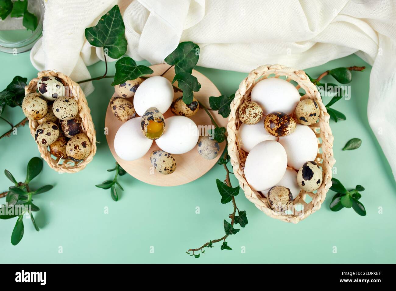 Flat lay easter composition with green leaves and easter eggs on a ...