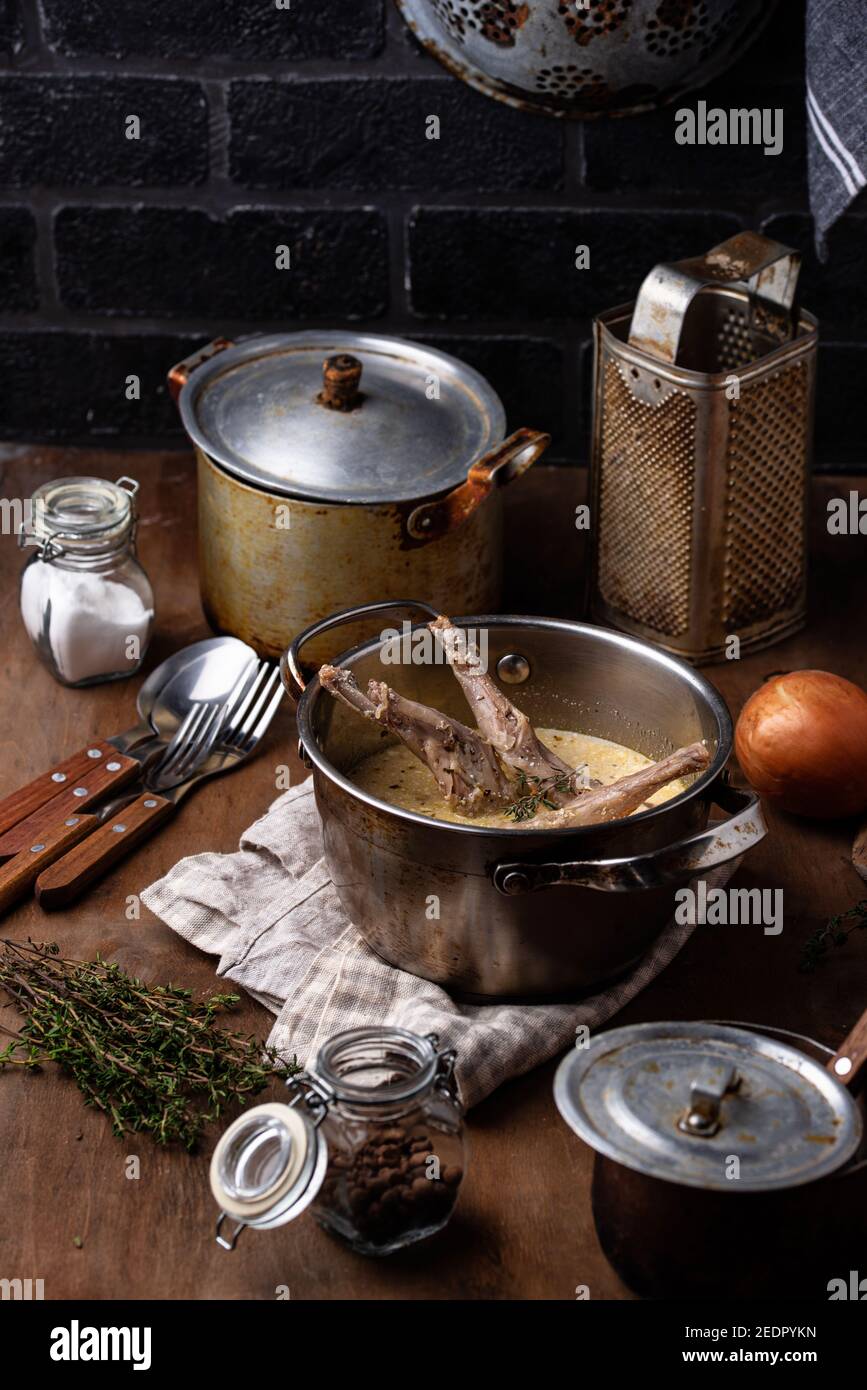 Stewed rabbit legs with sour cream Stock Photo