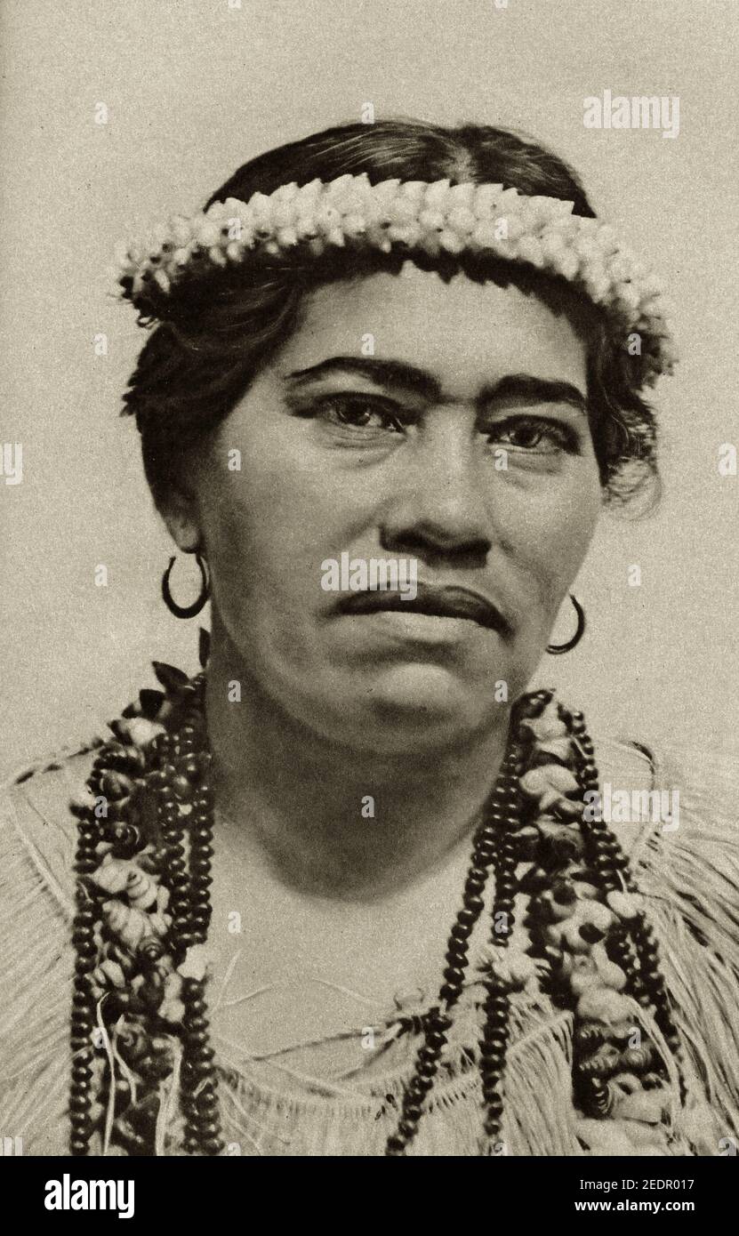 An early 20th century photo of a Maori woman wearing 'ei or seed necklace and a shell headdress Stock Photo