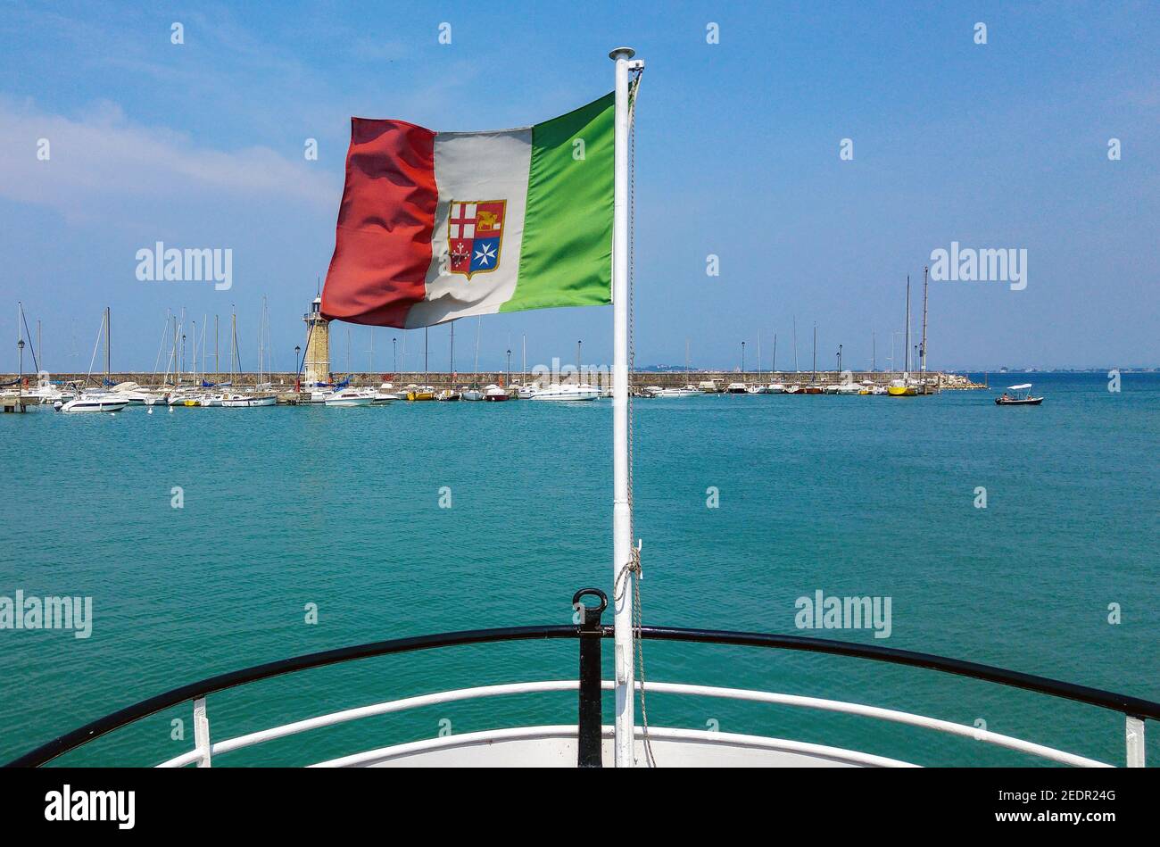 View from stern of ship with italian flag on pole. Stock Photo