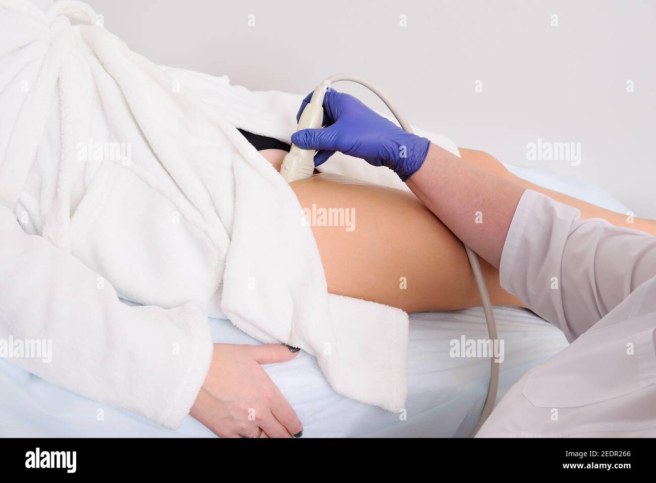 doctor makes an ultrasound of the veins and arteries of the lower extremities. Stock Photo