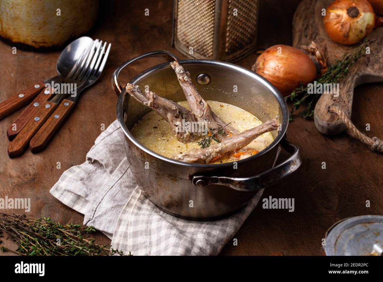 Stewed rabbit legs with sour cream Stock Photo