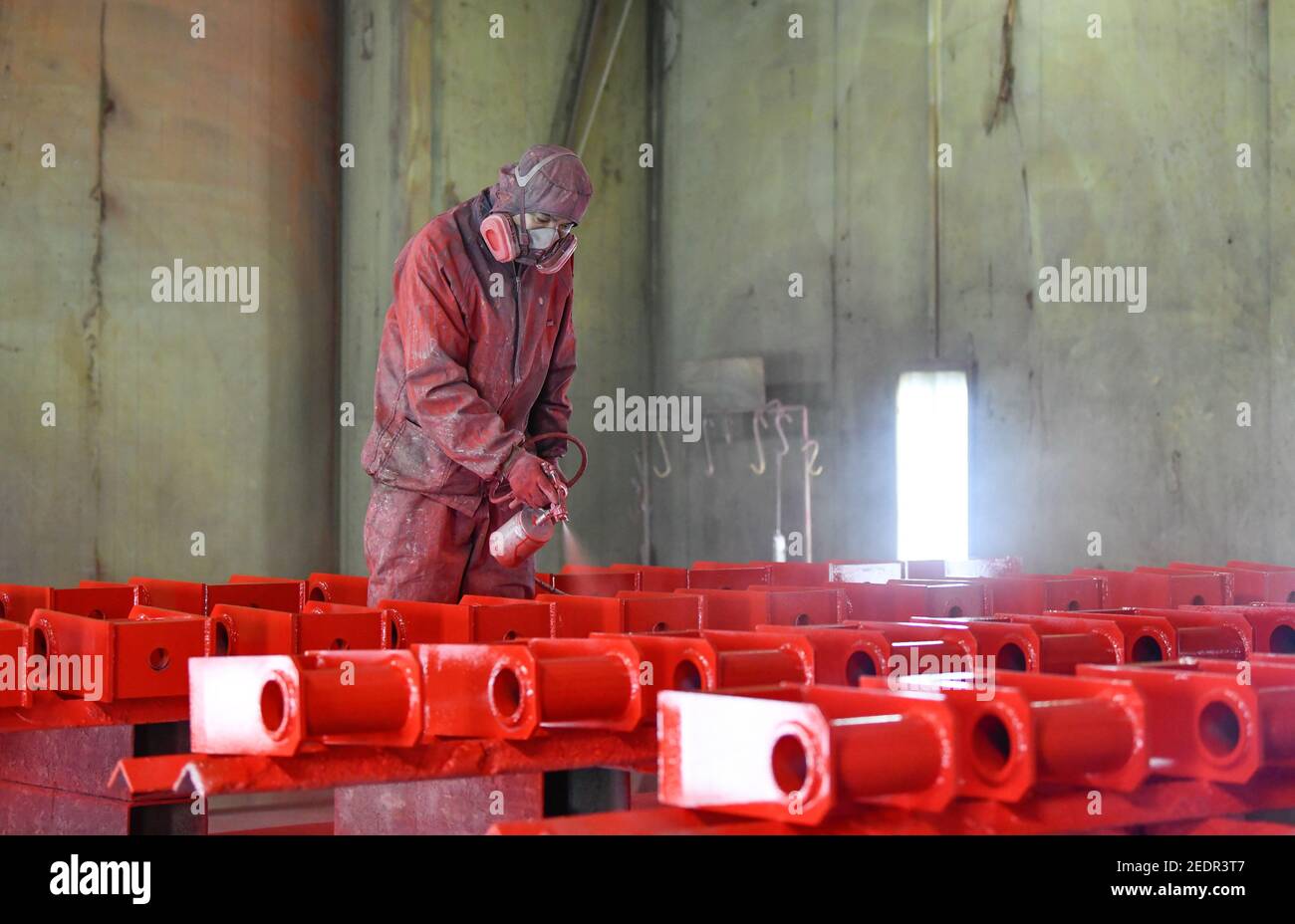 Tianjin, China. 14th Feb, 2021. A laborer works at a workshop of AE (Tianjin) Automotive Equipment Co., Ltd. in Tianjin, north China, Feb. 14, 2021. About 300 production workers of this company chose to stay put at their working position during this year's Spring Festival. Credit: Sun Fanyue/Xinhua/Alamy Live News Stock Photo