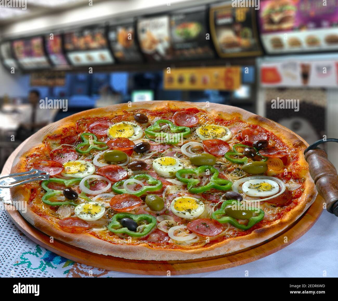 Portuguese Pizza, onion, peppers, pepperoni, egg, olive Stock Photo Alamy