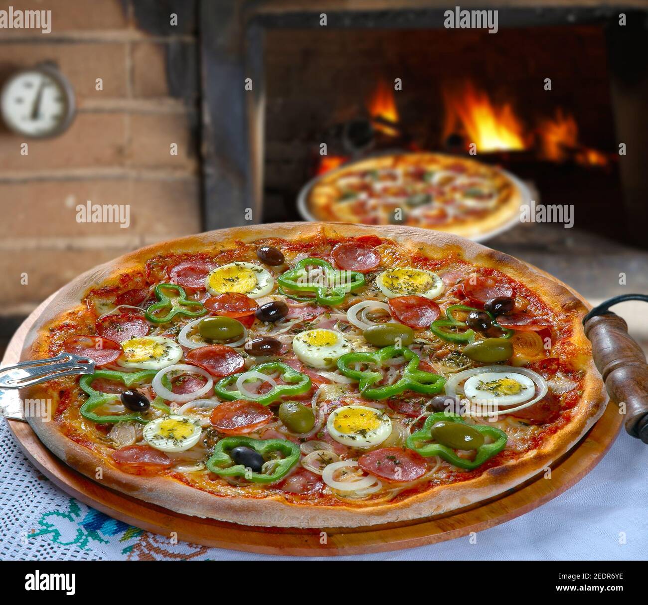 Portuguese Pizza, onion, peppers, pepperoni, egg, olive Stock Photo Alamy