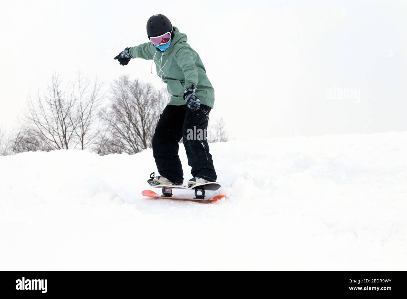 Woman riding a snowdeck snowskate snowboard on a snow slope in Canada  Quebec Stock Photo - Alamy