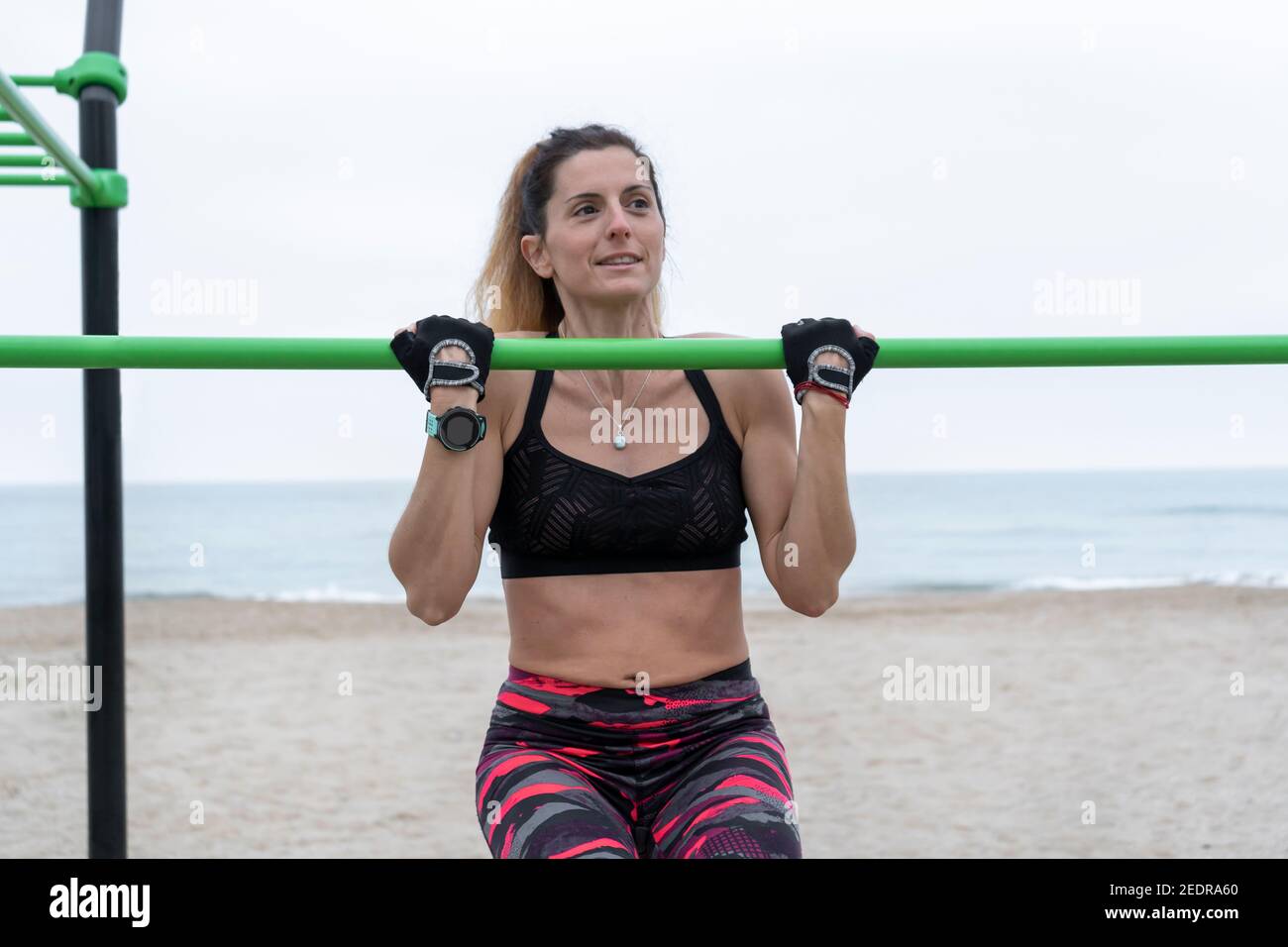 Strong athletic female doing pull up exercise in gym bars on beach.Fitness sportswoman during workout in calisthenics street outdoor gym bars Stock Photo Alamy