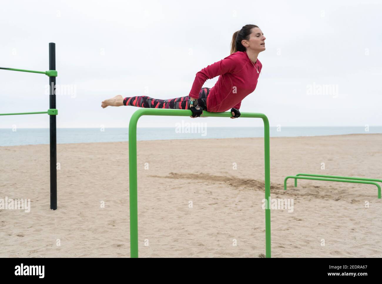 Fitness woman doing hand stand exercises on callisthenics outdoor gym bars.Beach workout sports training lifestyle concept Stock Photo Alamy