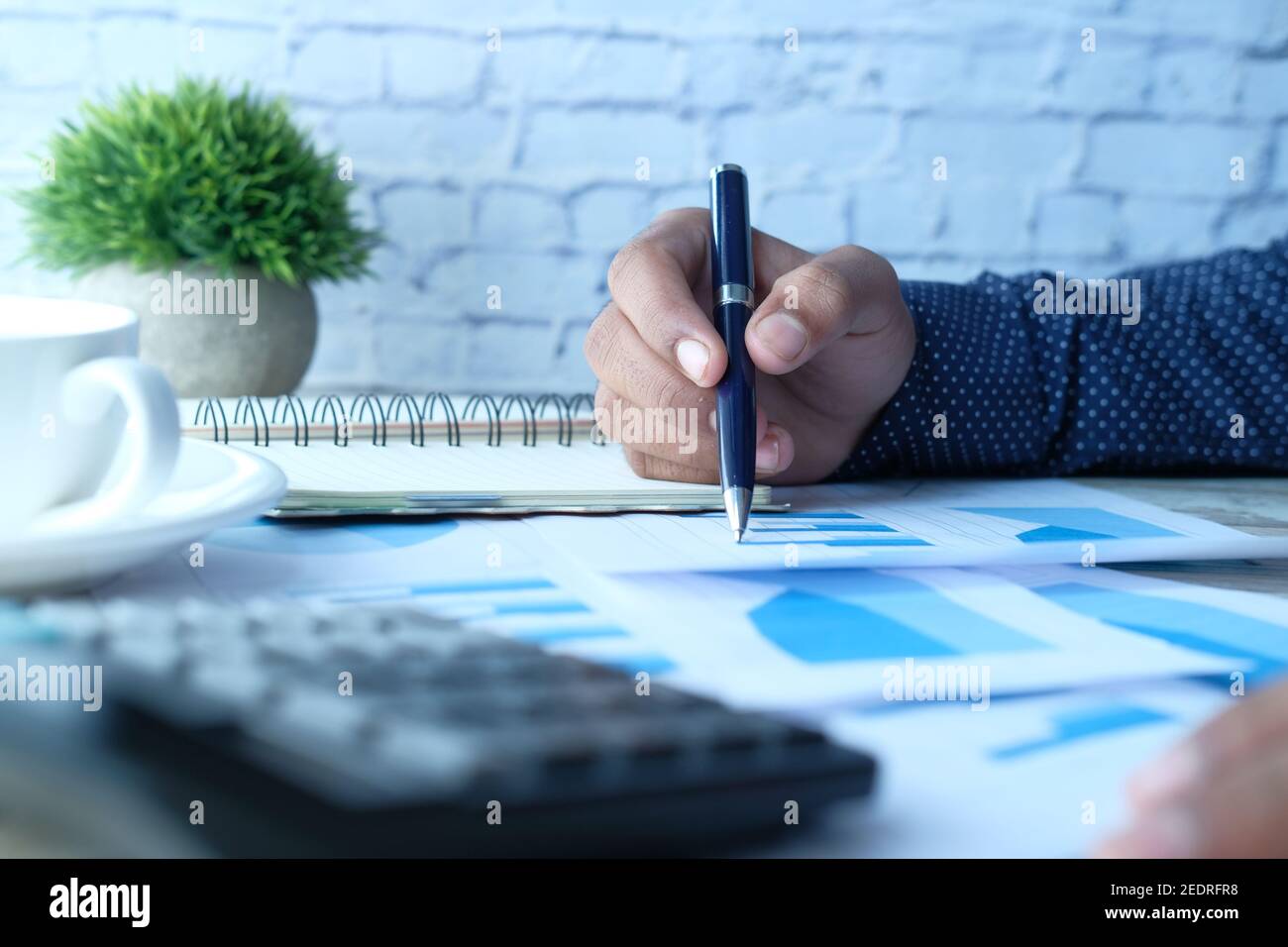 man hand with pen analyzing bar chart on paper Stock Photo - Alamy