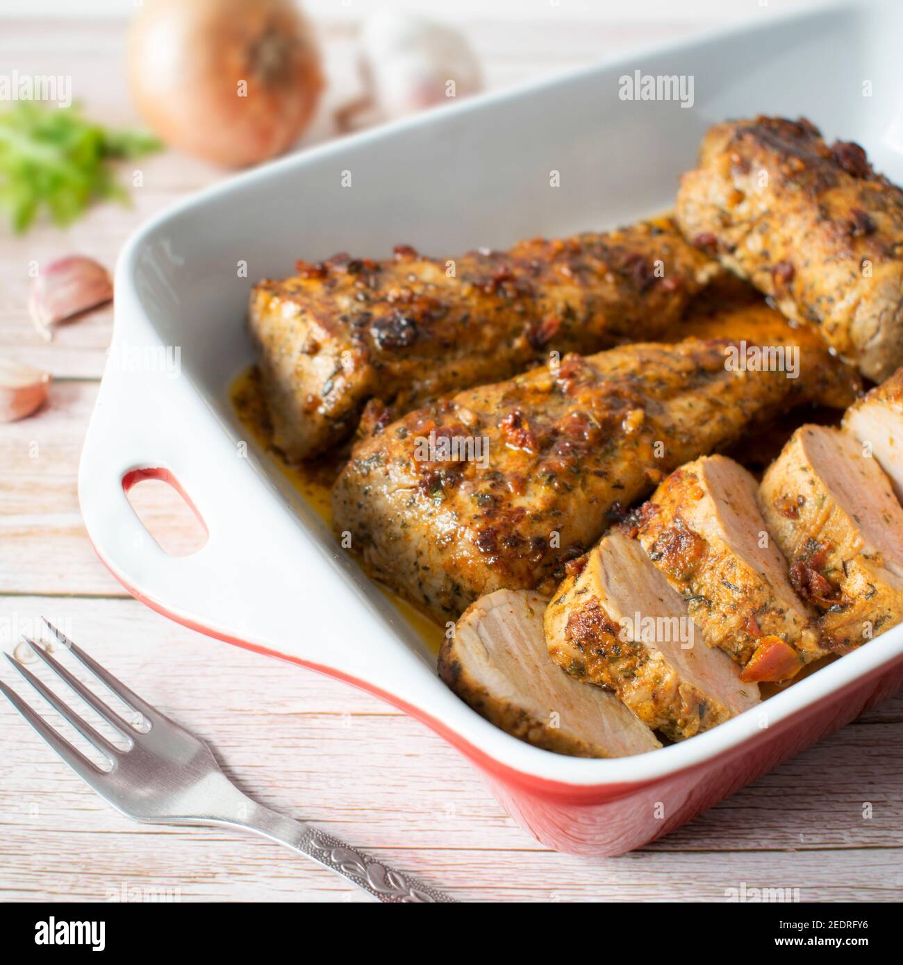 Baked tenderloin in a marinade with honey and sundried tomatoes Stock