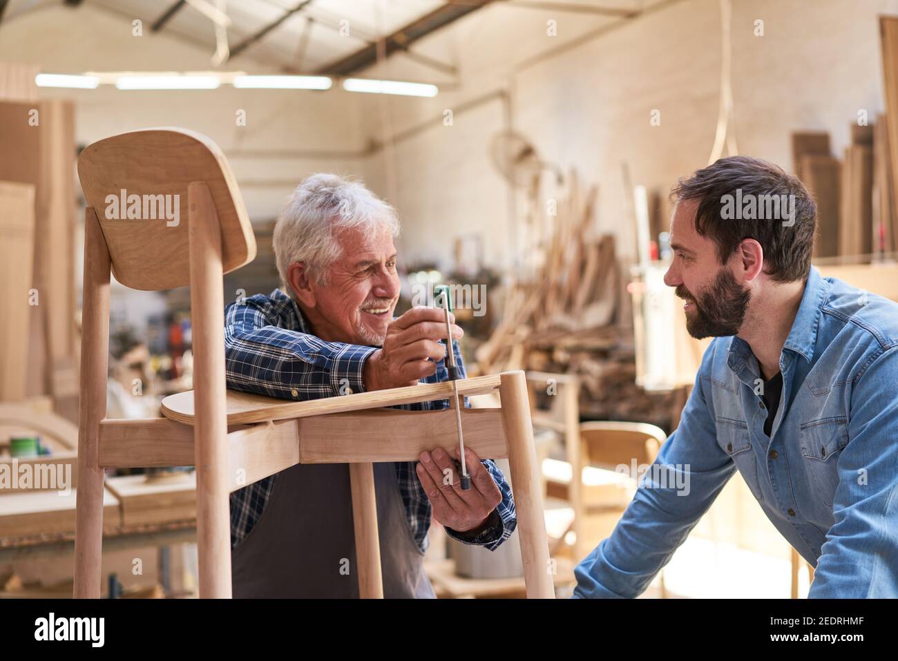 Craftsmen Masters and makers in training at gluing chairs Stock Photo Alamy