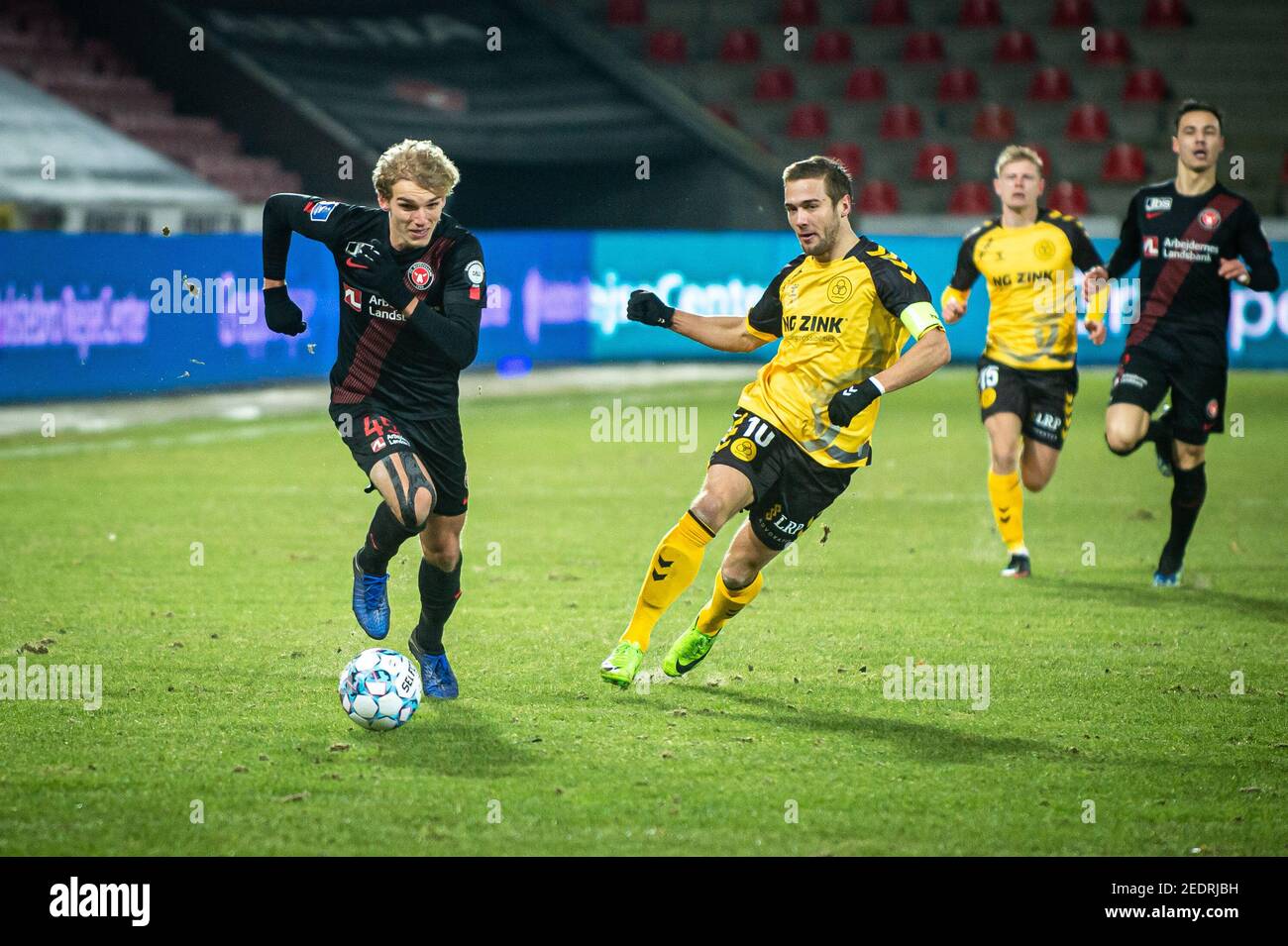 Herning, Denmark. 14th Feb, 2021. Gustav Isaksen (45) of FC Midtjylland and  Hallur Hansson (10) of AC Horsens seen during the 3F Superliga match  between FC Midtjylland and AC Horsens at MCH