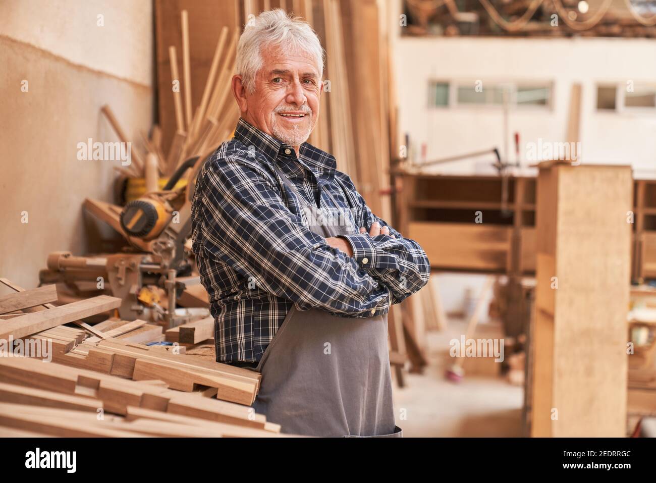 Satisfied senior as a master carpenter in his carpentry with