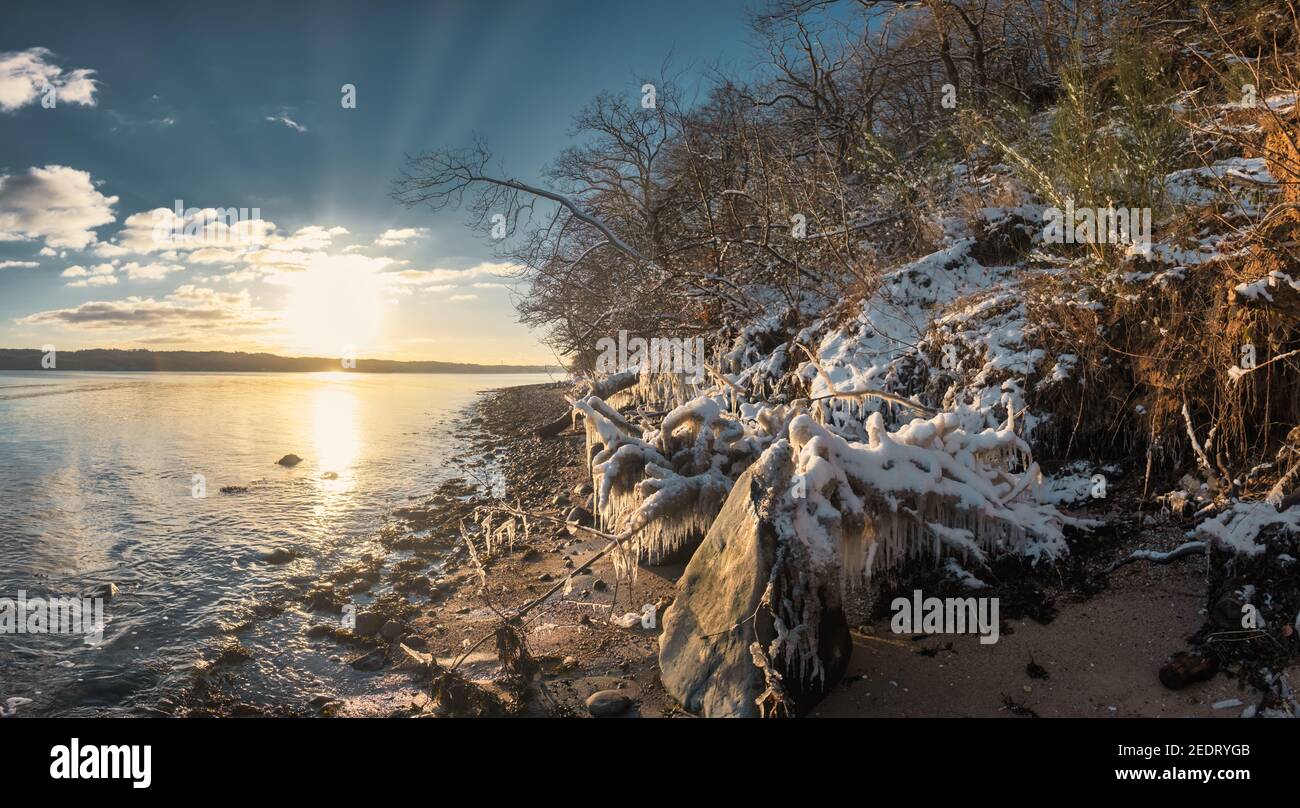 Snow and icicles at the fjord near Vejle in Dennmrk Stock Photo