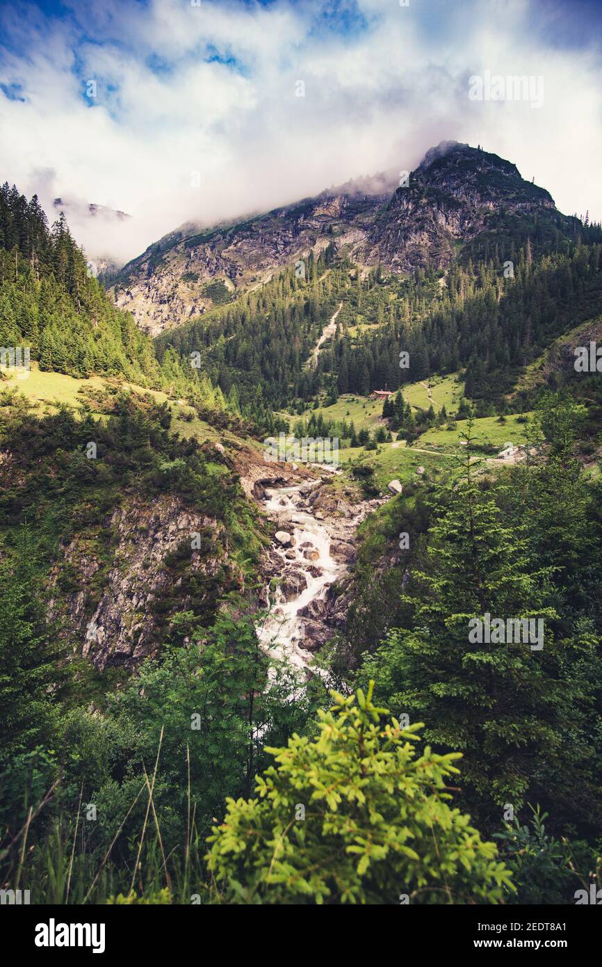 Vertical shot of a river in a mountain in alps Stock Photo - Alamy