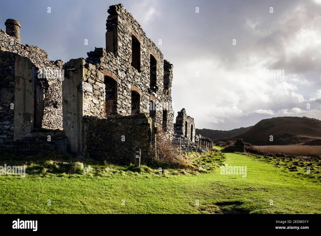 Remains of derelict old porcelain works building on Anglesey Coastal Path at Porth Llanlleiana Bay, Cemaes, Isle of Anglesey, North Wales, UK, Britain Stock Photo
