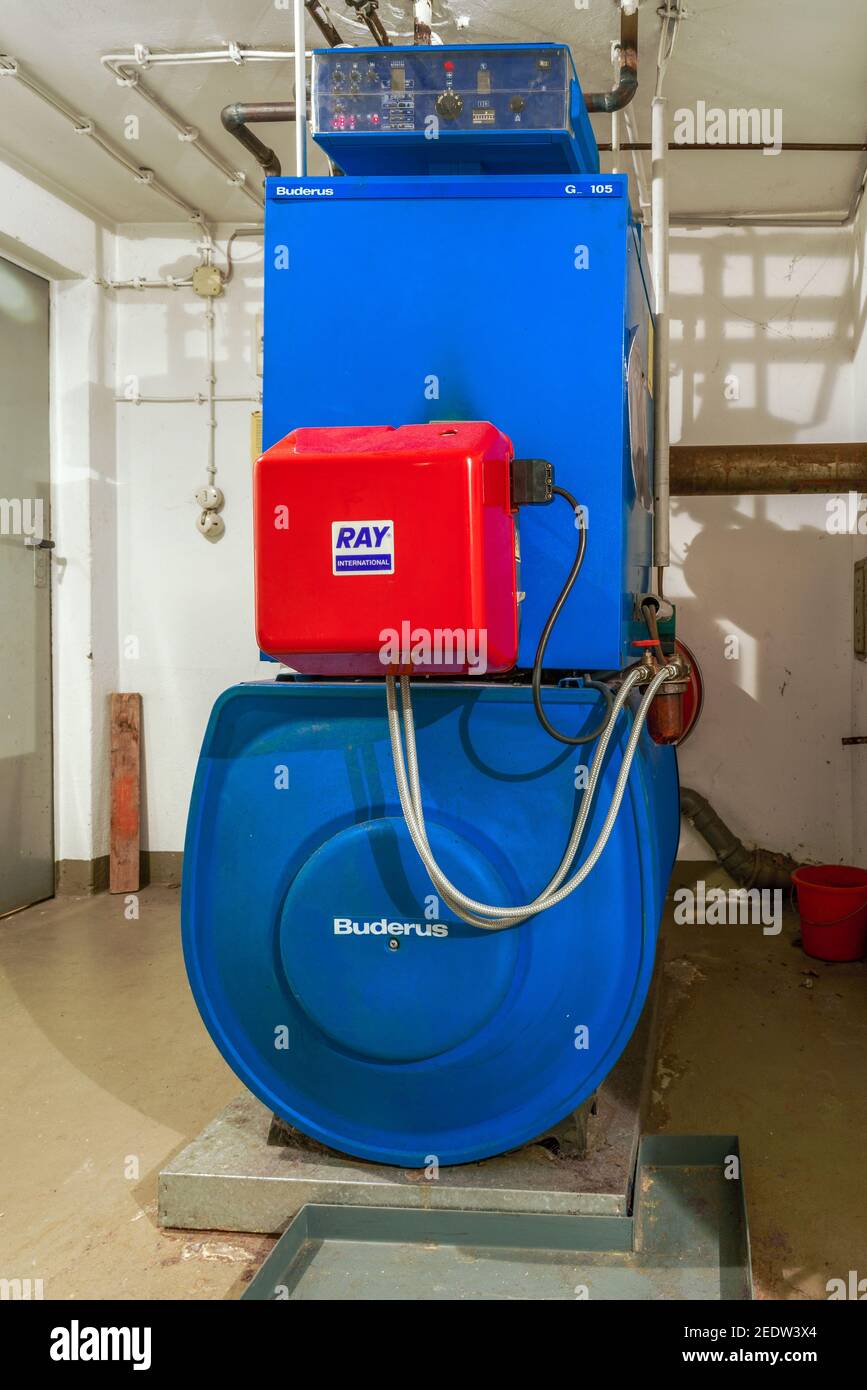 Old blue Buderus G 105 oil heating boiler with red Ray burner constructed in 1992 Stock Photo