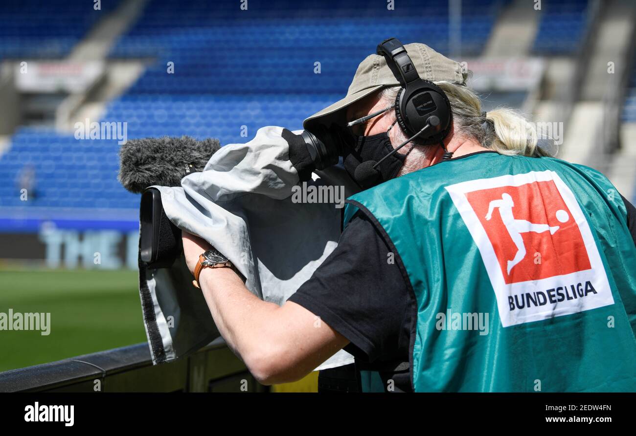 Soccer Football - Bundesliga - TSG 1899 Hoffenheim v Hertha BSC - PreZero  Arena, Sinsheim, Germany - May 16, 2020 A TV camera operator wears a  protective face mask before the match,