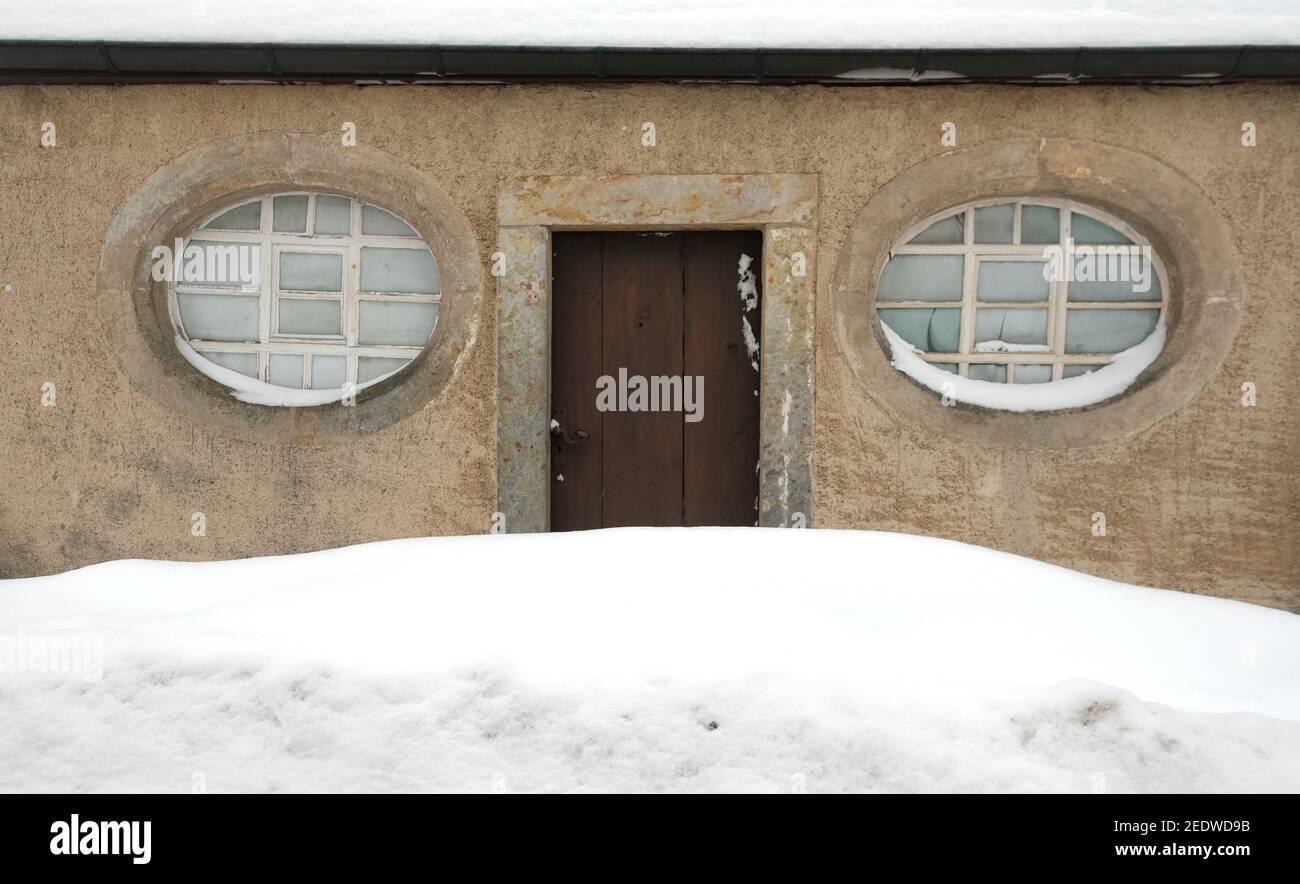 15 February 2021, Saxony, Kühnhaide: The door of the church in Kühnhaide, a  district of the Saxon town of Marienberg in the Erzgebirge district, is  surrounded by snow. On Monday night, according