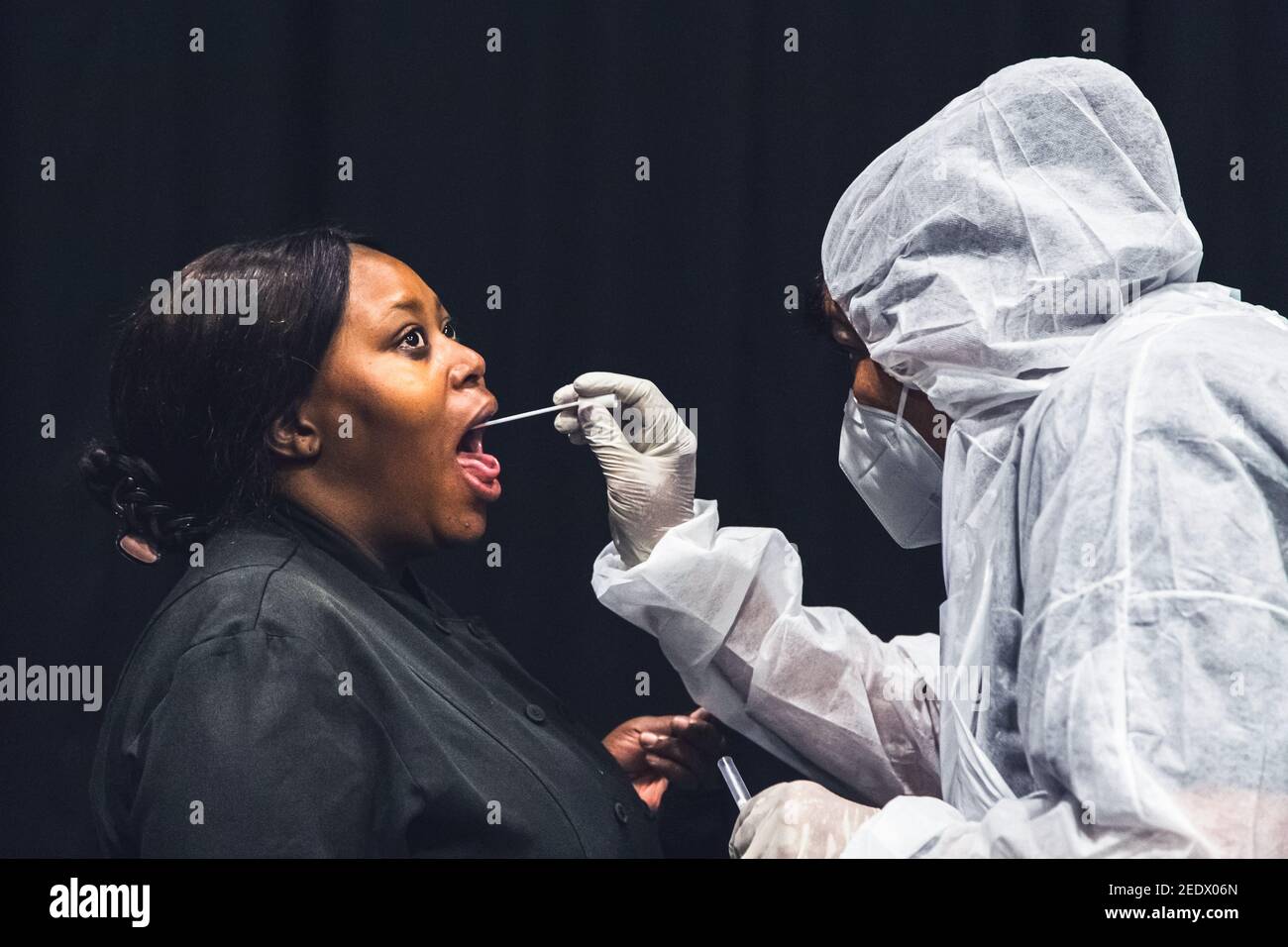 Johannesburg, South Africa - 4th February, 2021: Women being tested for viral infection with a swab in her throat. Stock Photo