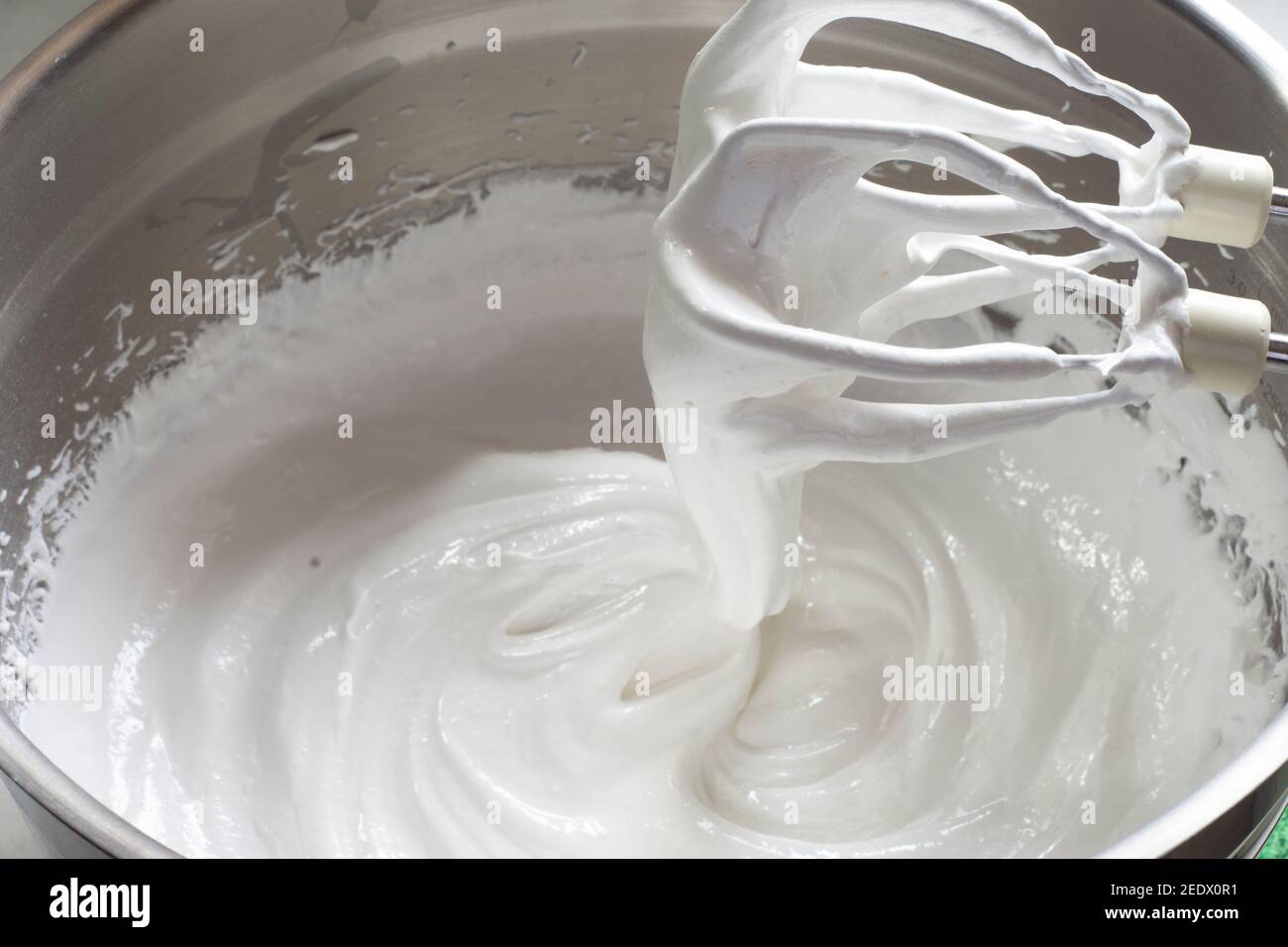 Pavlova dessert preparation stages. egg whites and sugar are whipped