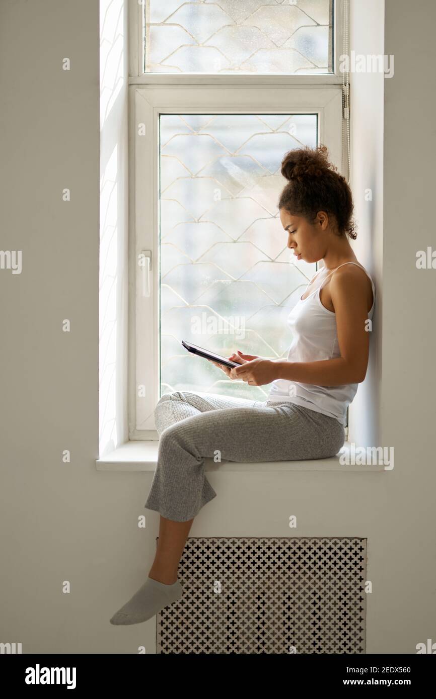 African woman sitting alone side view hi-res stock photography and ...