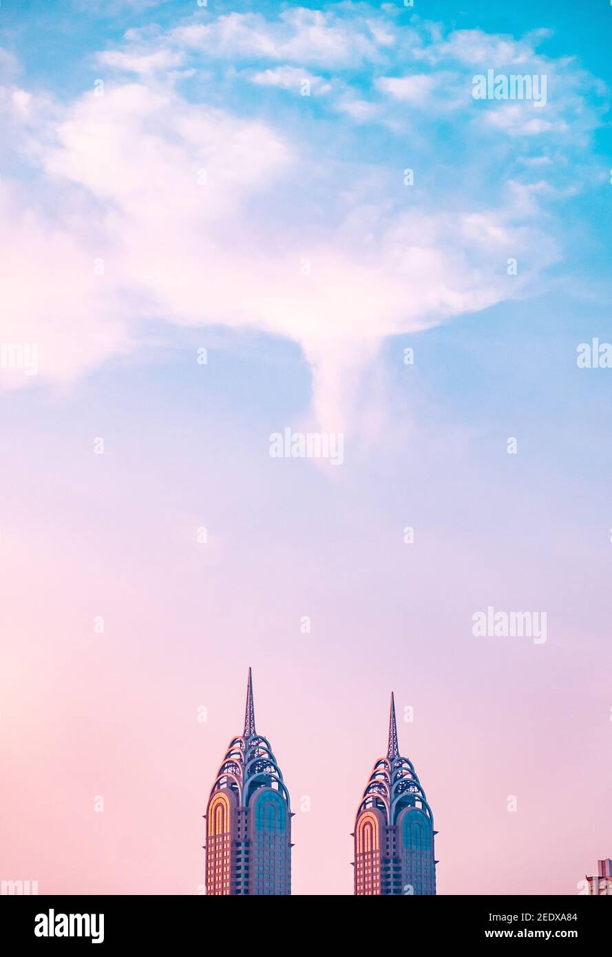 Vertical shot of the Dubai business center towers during a colorful sunset Stock Photo