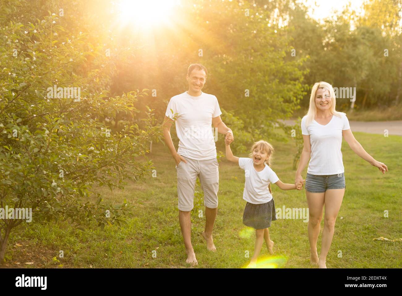 Happy family enjoying in park on sunny a day Stock Photo - Alamy
