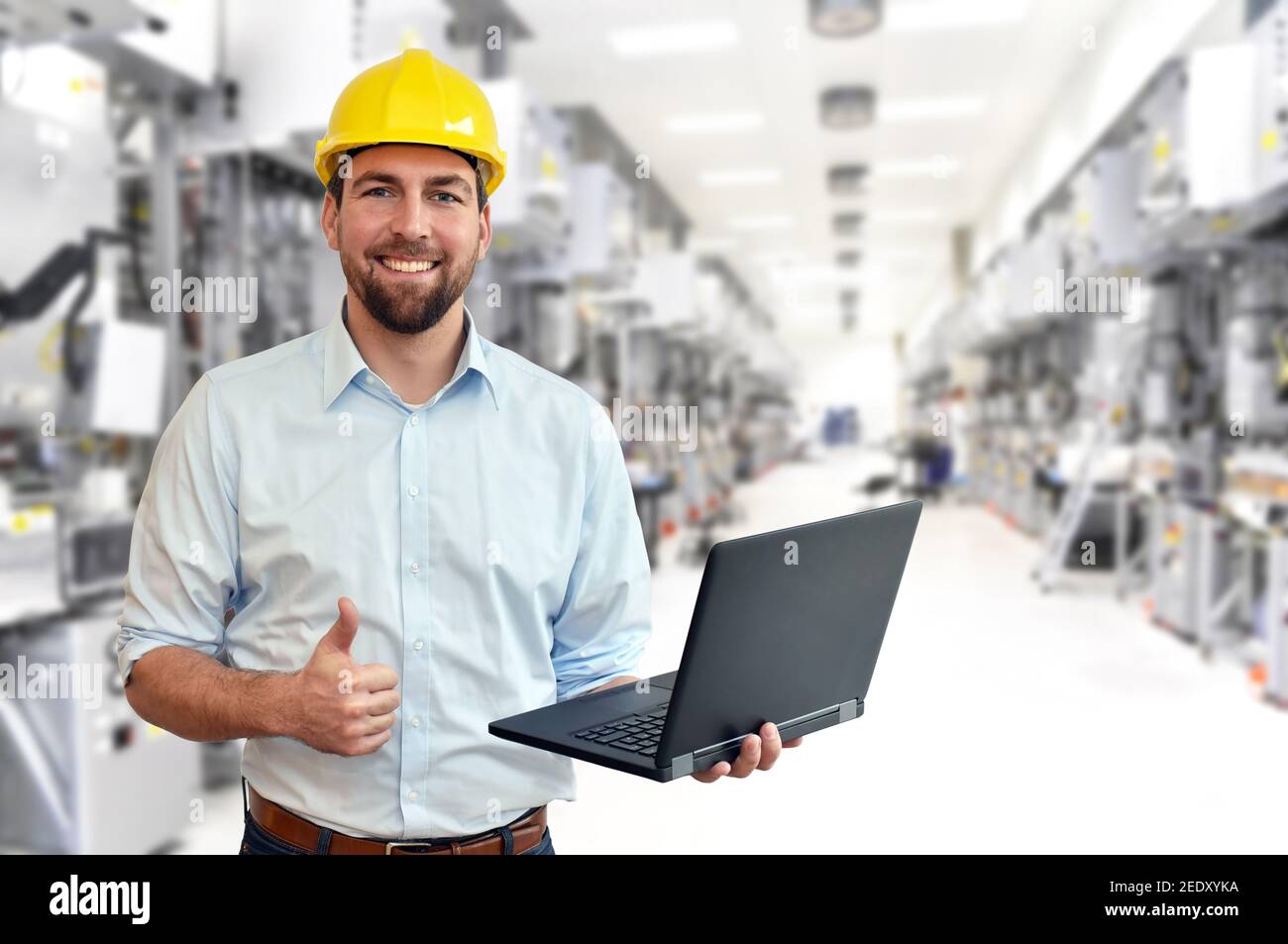 engineer at his workplace with notebook in an industrial company in microchip manufacturing plant Stock Photo
