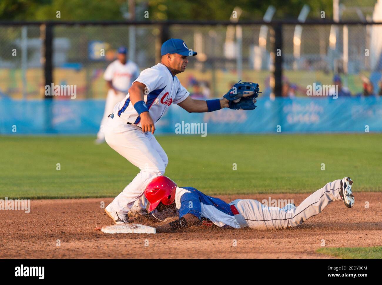 Toronto Panam Baseball 2015-Cuba vs the Dominican Republic: Dominican player steals second base and arrives save sliding with his hands Stock Photo