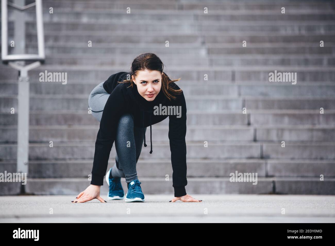 Woman in sports clothes ready to run. Athlete. Fit lifestyle. Professional sportswoman. Stock Photo