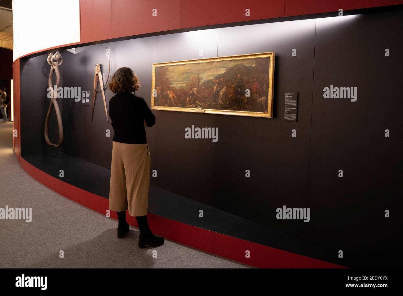 A visitor observes the exhibition 'Ingenuity at the service of power. The codices of Leonardo da Vinci in the Austrian court' at the San Fernando Academy of Fine Arts in Madrid. Stock Photo