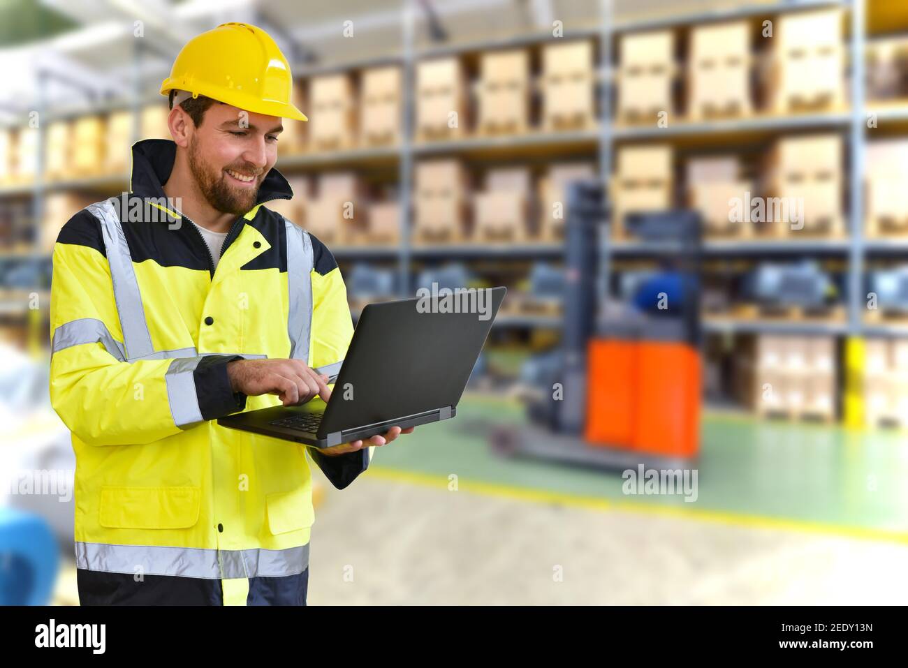 portrait successful manager works in merchandise trade in logistics -in the background depot with goods Stock Photo