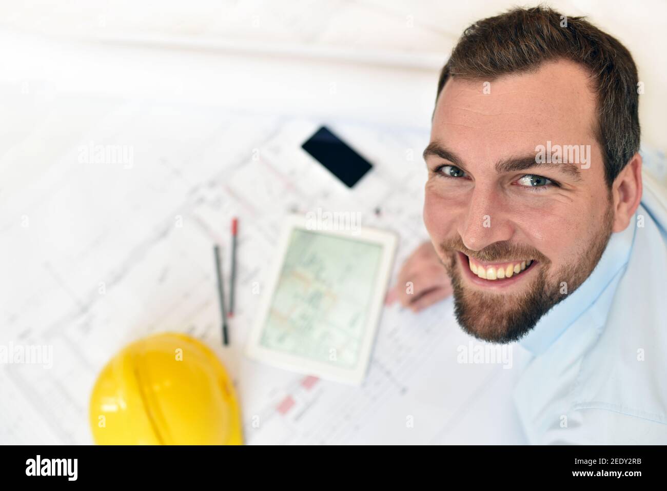 Architect / engineer at his desk planning the construction of a house