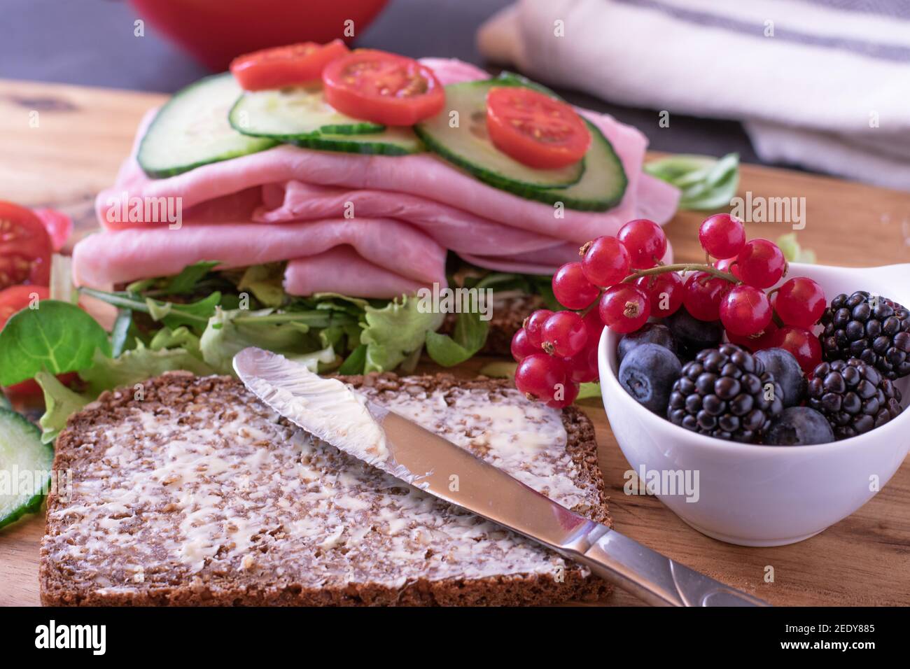 Post Workout meal with delicious sandwich, vegetables and berries Stock Photo