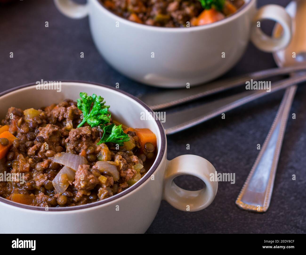 Spicy mediterranean lentil stew with minced meat and vegetables served in soup cups Stock Photo