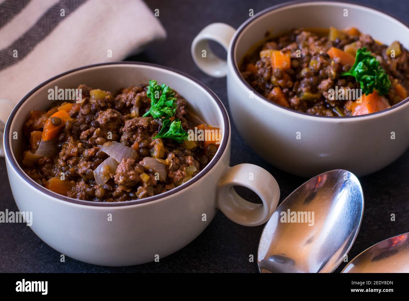 Spicy mediterranean lentil stew with minced meat and vegetables served in soup cups Stock Photo