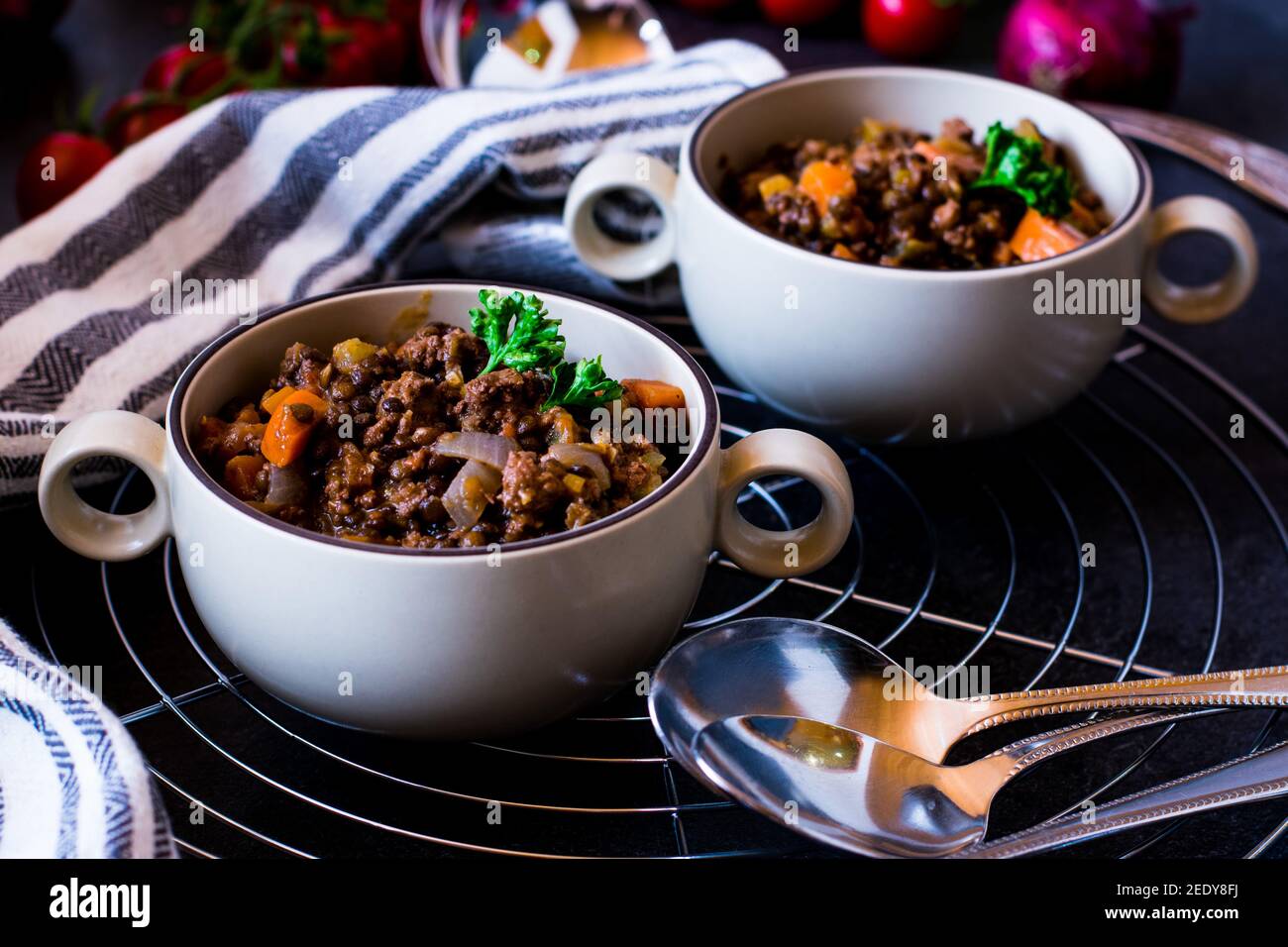 Spicy mediterranean lentil stew with minced meat and vegetables served in soup cups Stock Photo