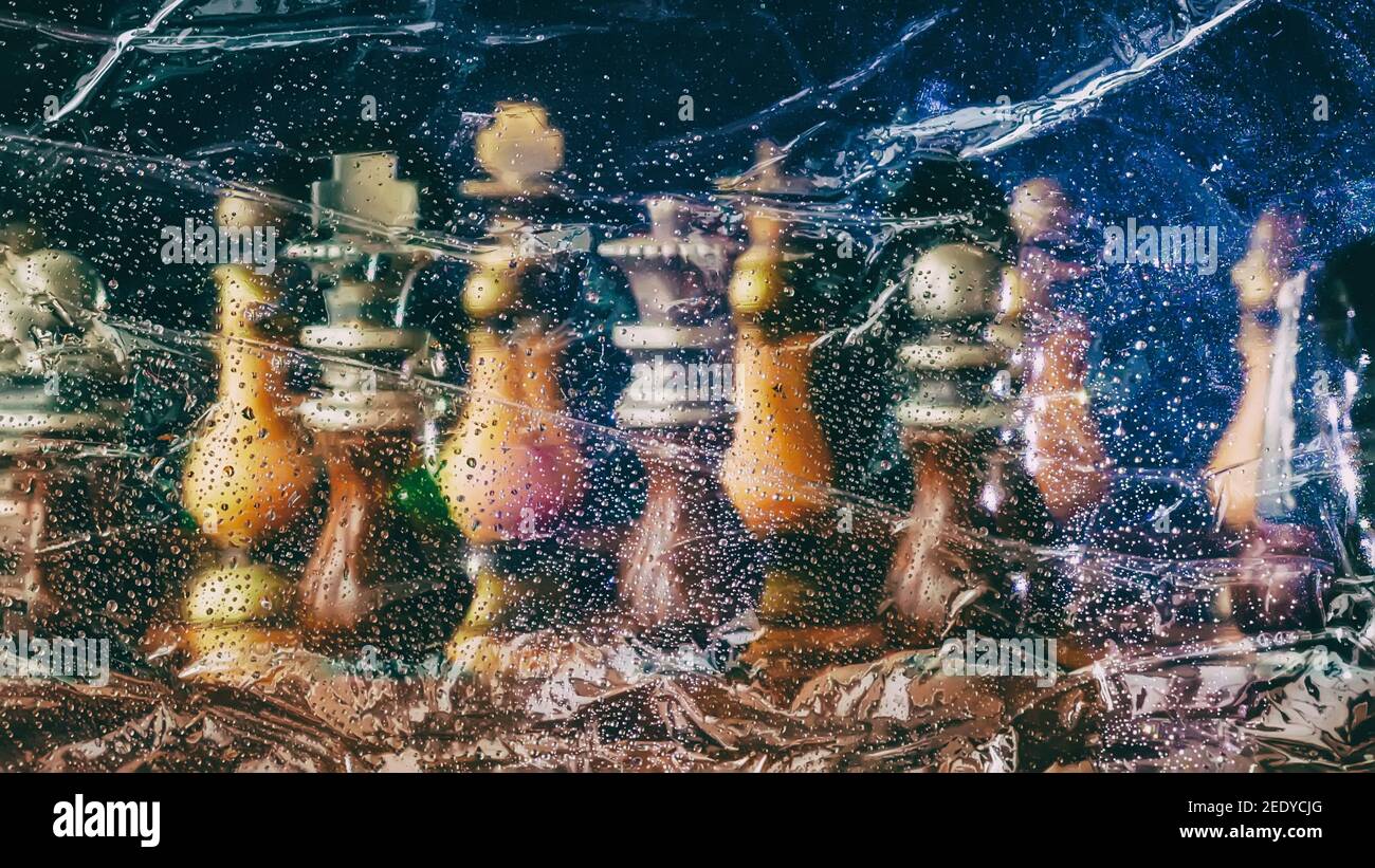 Blurred mystic fantasy with Chess figures on dark background. Surreal landscape, with raindrops, smoke and fog Stock Photo