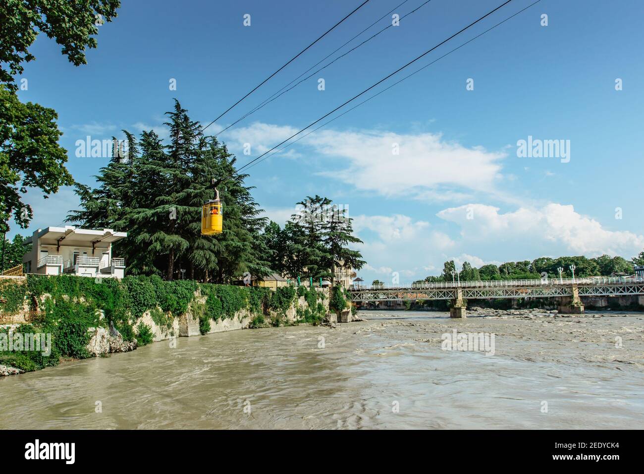 Ropeway station by river Rioni, Kutaisi. You can rise up on the hill above Kutaisi with retro yellow cable car. Populat tourist attraction.Enjoy Stock Photo
