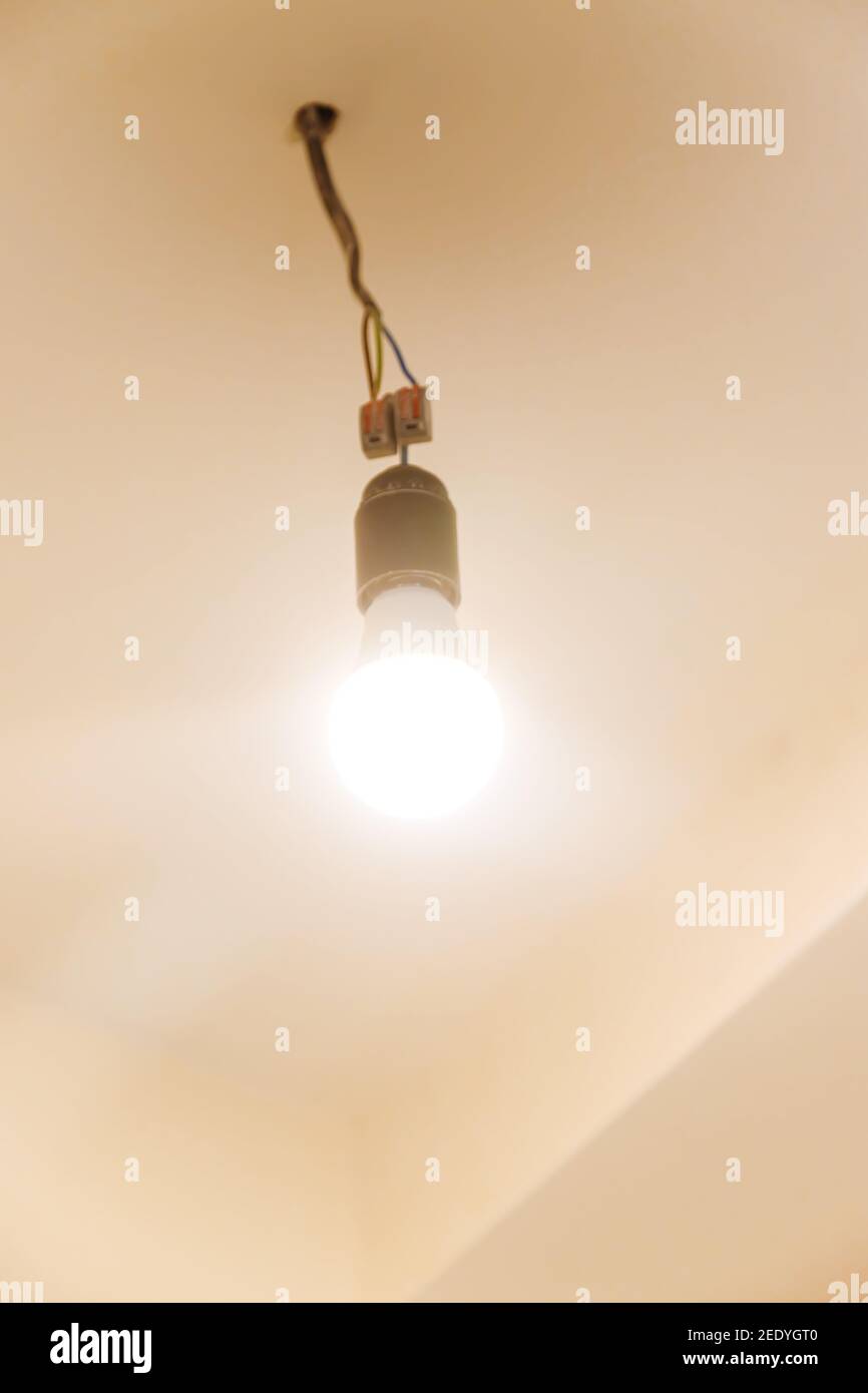 Light bulb on the ceiling in the house. Selective focus. white. Stock Photo