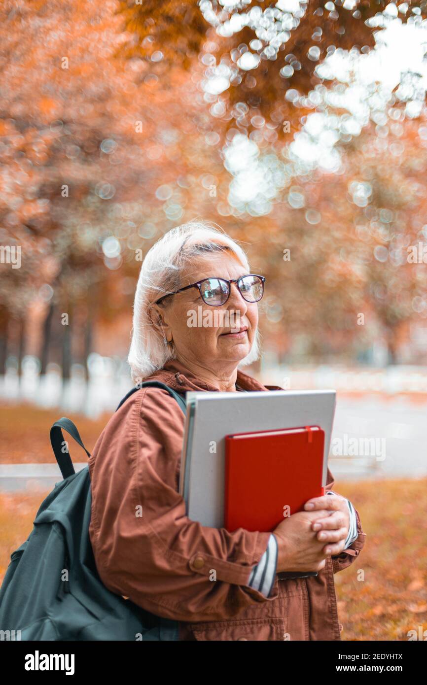 Mature teacher holding glasses hi-res stock photography and images - Alamy