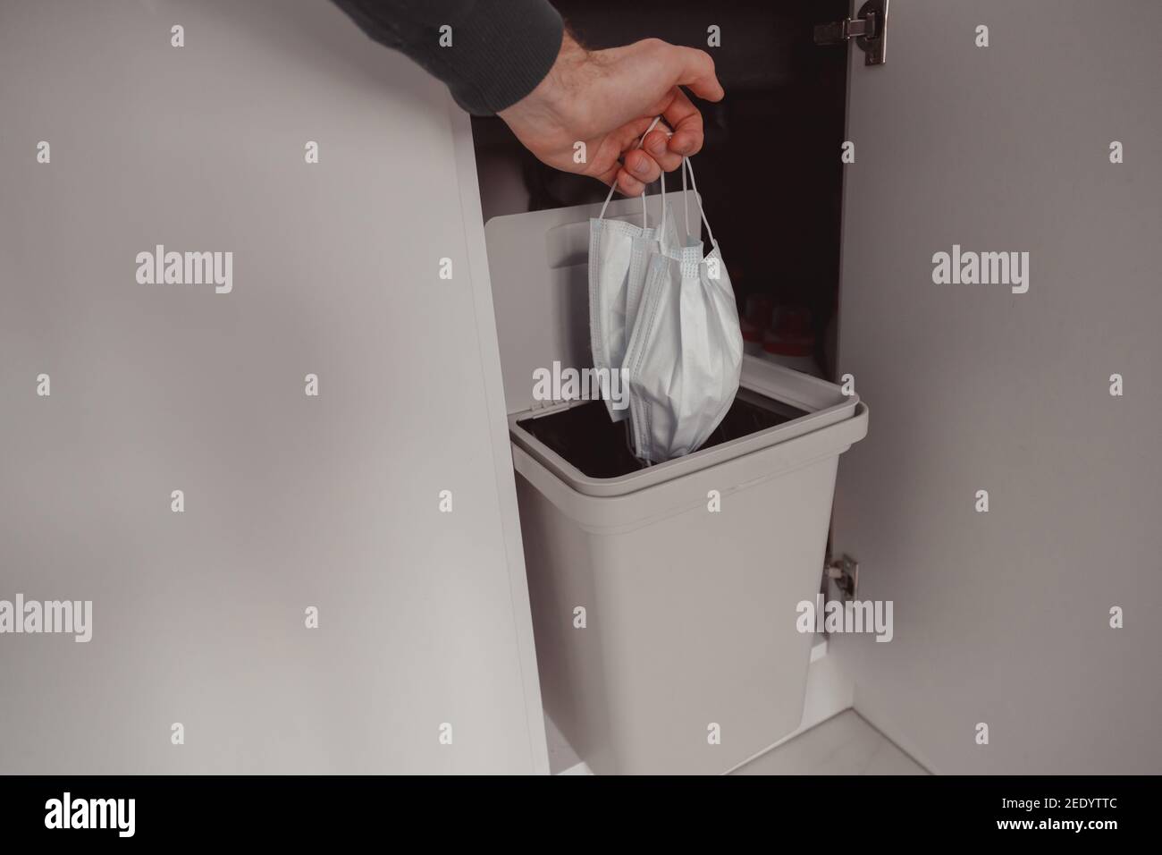 The used face mask is dumped in a trash. Disposal of disposable ...