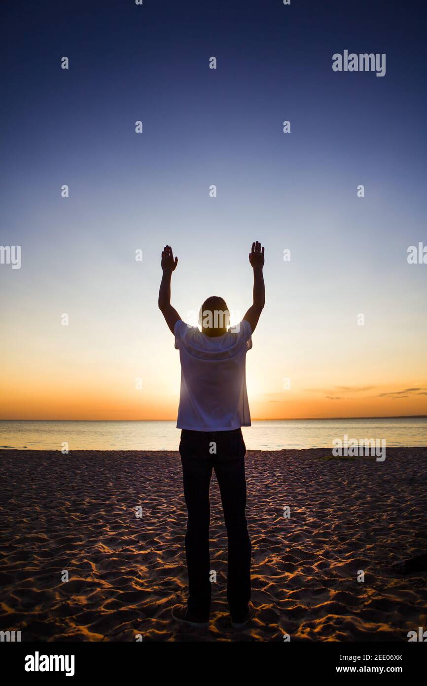 Man Silhouette with Hands Up at the Sun Background Stock Photo - Alamy