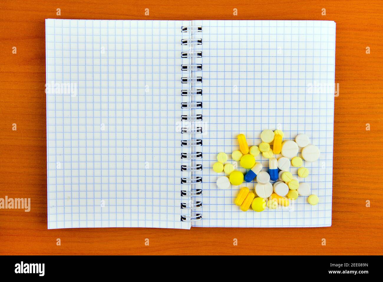 Writing Pad and the Pills on the Wooden Table closeup Stock Photo