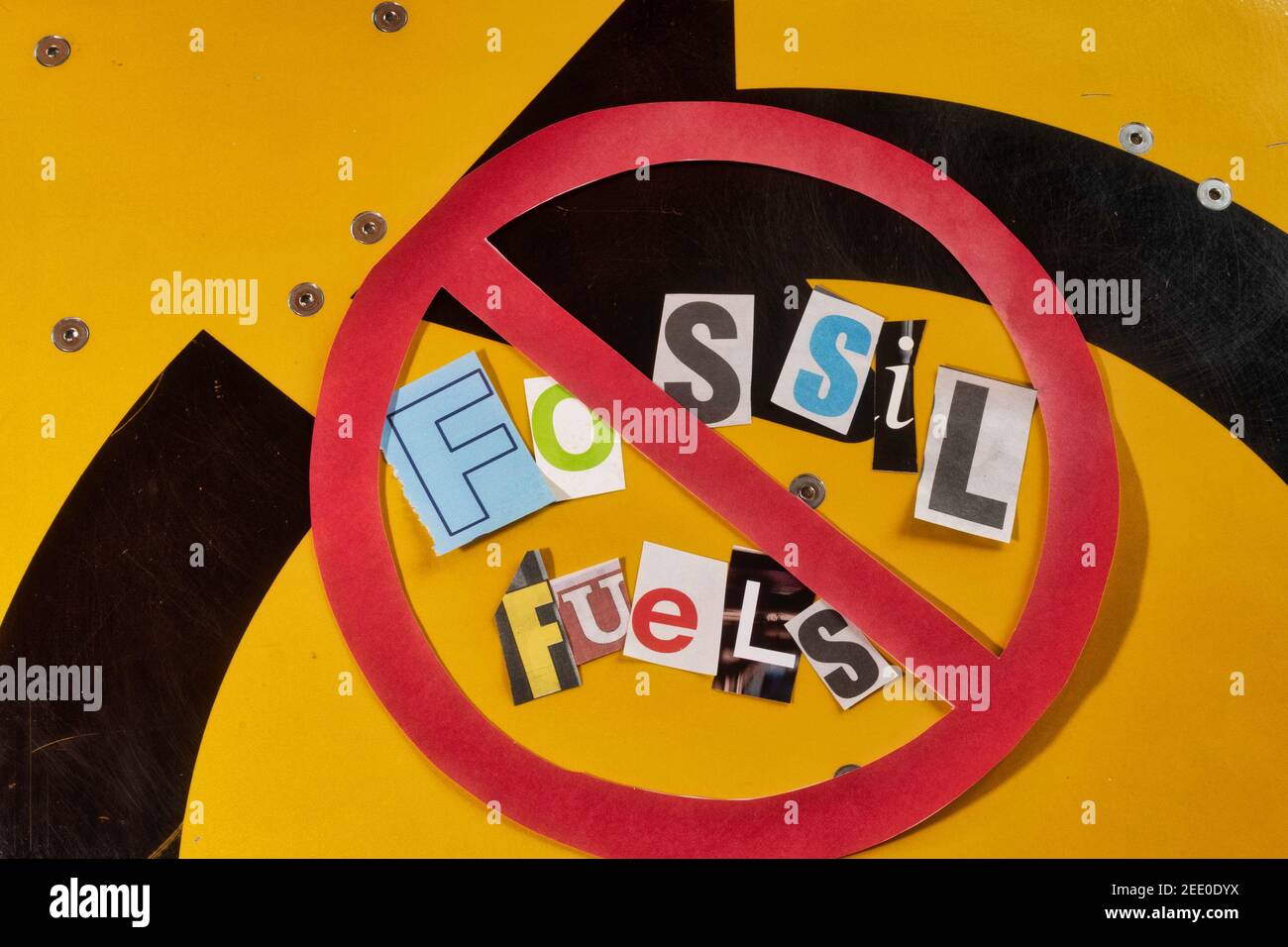 The Concept of 'Cancel Fossil Fuels' using cut-out paper letters in the ransom note effect typography inside The International NO Symbol, USA Stock Photo