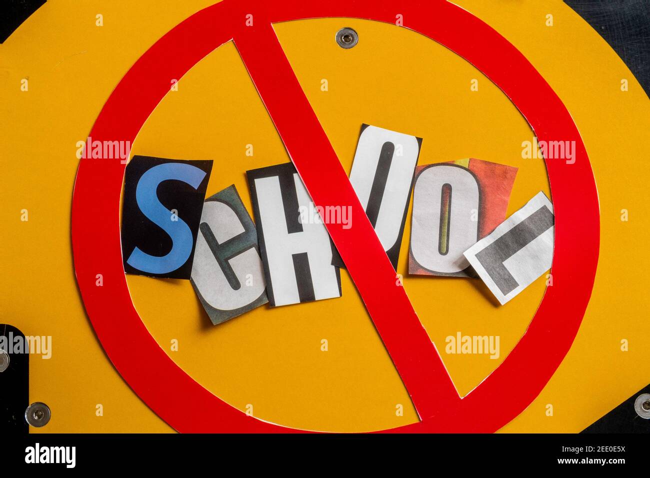 The Concept of 'Cancel School ' using cut-out paper letters in the ransom note effect typography inside The International NO Symbol, USA Stock Photo