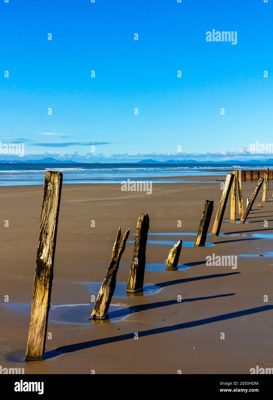 The sandy beach at Barmouth Bay or Abermaw in Gwynedd on the north west coast of Wales with the mountains of Snowdonia in tne distance. Stock Photo